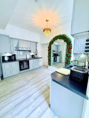a large kitchen with a christmasreath on the wall at Vance Holiday Home in Blackpool