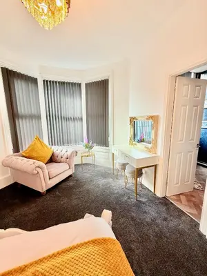 a living room with a couch and a table at Vance Holiday Home in Blackpool