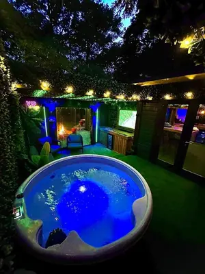 a large swimming pool in a backyard at night at Woodland Escapes Glamping - Utopia