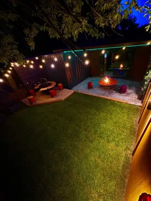 a backyard at night with a fire pit and lights at Woodland Escapes Glamping - Utopia