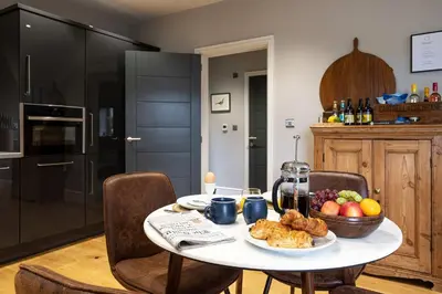 a kitchen with a table with a bowl of food on it at Hen Harrier Lodge in Lancaster