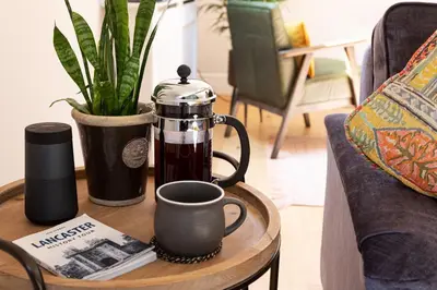 a coffee maker on a table with a cup of coffee at Bowland Lodges in Lancaster