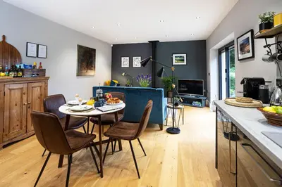 a kitchen and dining room with a table and chairs at Bowland Lodges in Lancaster