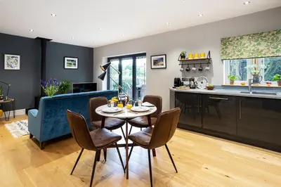 a kitchen and living room with a table and chairs at Bowland Lodges in Lancaster