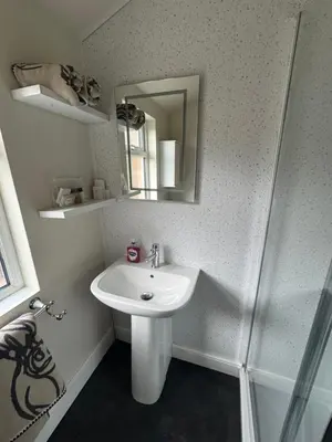 a bathroom with a sink and a mirror at The Hollies in Crosby
