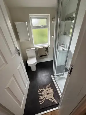 a small bathroom with a toilet and a shower at The Hollies in Crosby