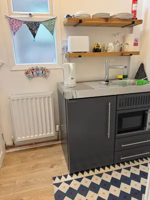 a kitchen with a sink and a stove at The Hollies in Crosby