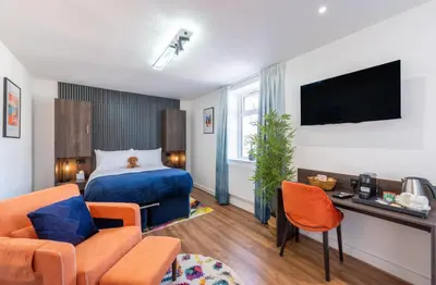 a hotel room with a bed and a tv at The Old Brewery - A St David Aparthotel in Barrow in Furness