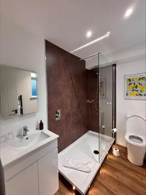 a bathroom with a shower and a sink and a toilet at The Old Brewery - A St David Aparthotel in Barrow in Furness