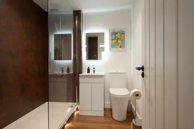a bathroom with a shower and a toilet and a sink at The Old Brewery - A St David Aparthotel in Barrow in Furness