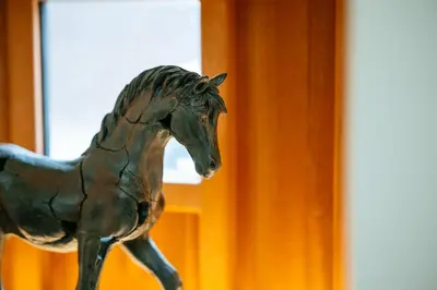 a statue of a horse walking in front of a window at The Stables at The Talbot in Lytham St Annes