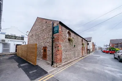 a brick building on the side of a street at The Stables at The Talbot in Lytham St Annes