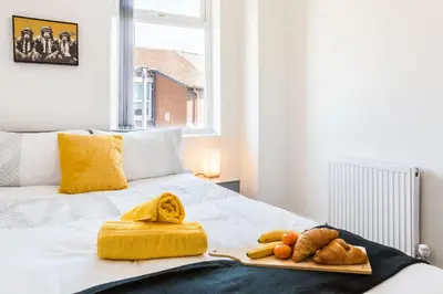 a tray with bread and vegetables on a bed at Leisure Stays with Wifi Close to Anfield, sleeps 8 in Liverpool