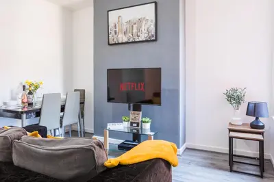 a living room with a couch and a tv at Leisure Stays with Wifi Close to Anfield, sleeps 8 in Liverpool
