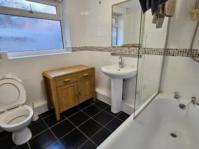 a bathroom with a toilet and a sink and a shower at Comfort in Liverpool