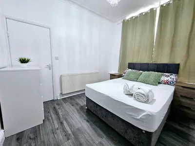 a bedroom with a bed with towels on it at Comfort in Liverpool