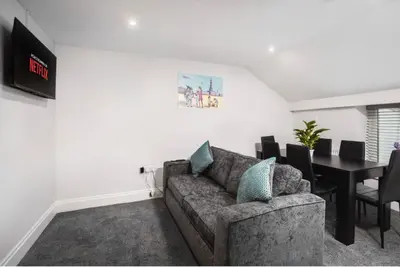 a living room with a couch and a table at Polaris Apartments in Blackpool