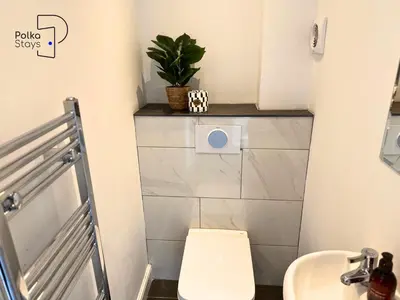 a bathroom with a toilet and a sink at No 2 PolkaStays Ivy Farm Rosewood Cottage in Plumpton