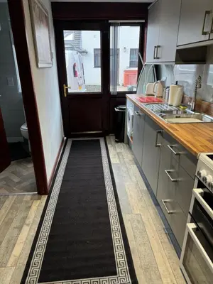 a kitchen with a hallway leading to the door at Beech barn in Standish
