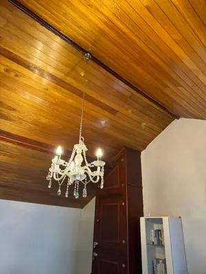 a chandelier hanging from a wooden ceiling in a room at Beech barn in Standish