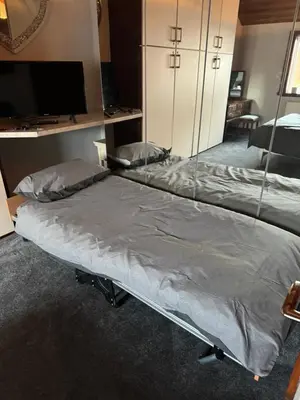 a bed in a room with a mirror at Beech barn in Standish