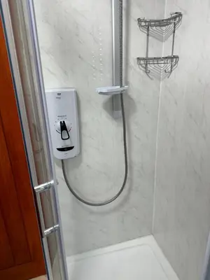 a bathroom with a shower with a shower head at Beech barn in Standish