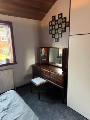 a bedroom with a dresser and a mirror at Beech barn in Standish