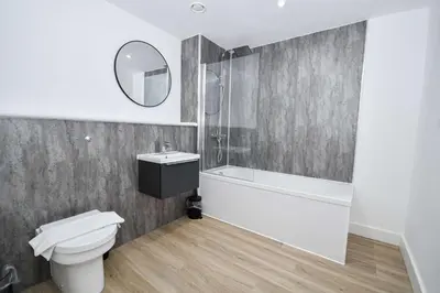 a bathroom with a toilet and a sink and a mirror at Modern & Spacious 2 Bedroom Liverpool Apartment in Liverpool