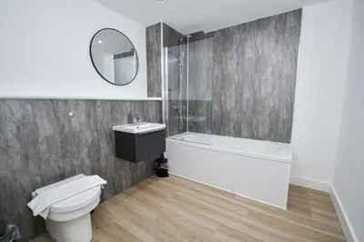 a bathroom with a toilet and a sink and a mirror at Modern & Spacious 2 Bedroom Liverpool Apartment in Liverpool