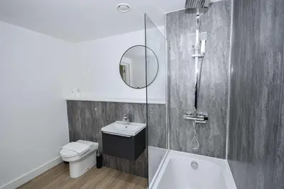 a bathroom with a toilet and a sink and a mirror at Modern & Spacious 2 Bedroom Liverpool Apartment in Liverpool
