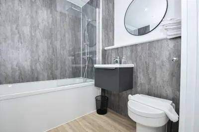 a bathroom with a white toilet and a mirror at Bright & Spacious 2 Bed Apartment in Liverpool in Liverpool
