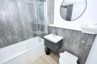 a bathroom with a sink toilet and a mirror at Bright & Spacious 2 Bed Apartment in Liverpool in Liverpool