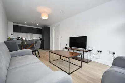 a living room with a couch and a table at Bright & Spacious 2 Bed Apartment in Liverpool in Liverpool