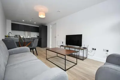 a living room with a couch and a table at Bright & Spacious 2 Bed Apartment in Liverpool in Liverpool
