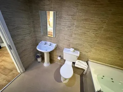 a bathroom with a toilet and a sink and a tub at White Star Line Hotel in Liverpool
