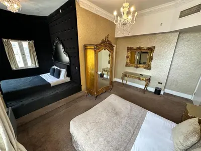 a bedroom with two beds and a mirror at White Star Line Hotel in Liverpool