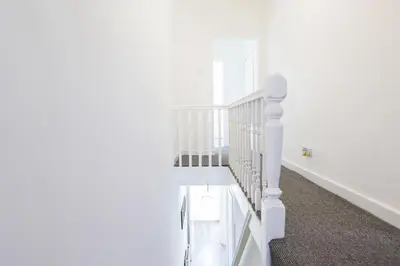 a white staircase in a white room at Contractors House with Parking City Area, sleeps 8 in Liverpool