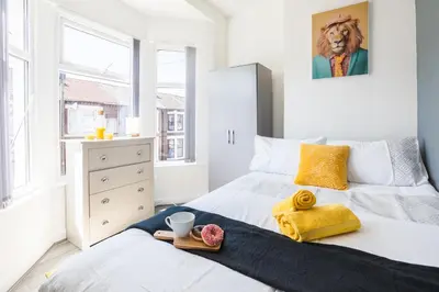 a bedroom with a bed with a lion picture on the wall at Contractors House with Parking City Area, sleeps 8 in Liverpool