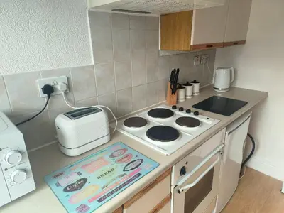 a kitchen with a stove and a toaster on a counter at Springfield house holiday apartments in Blackpool