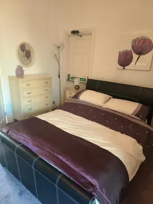 a bedroom with a large bed and a dresser at springfield house in Blackpool