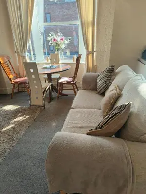 a living room with a couch and a table at springfield house in Blackpool