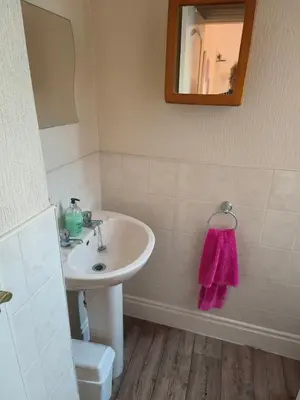 a bathroom with a sink and a mirror and a toilet at springfield house in Blackpool