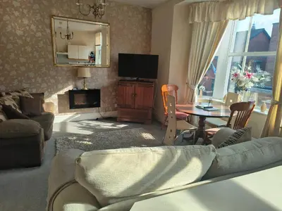 a living room with a couch and a table at springfield house in Blackpool