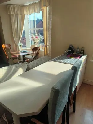 a room with two beds and a table and a window at springfield house in Blackpool