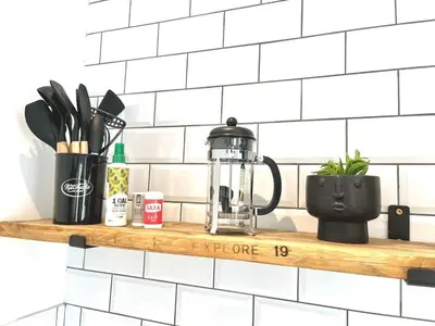 a kitchen shelf with a coffee maker and utensils at Ideal 4 Bed Home sleeps 7 Nr Middlebrook Stadium in Lostock