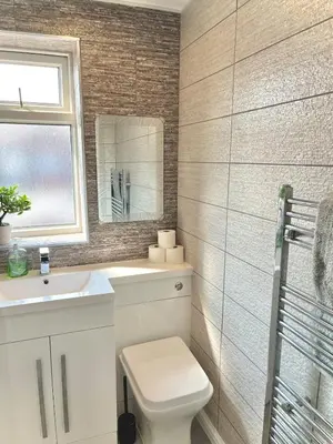 a bathroom with a toilet and a sink and a mirror at Ideal 4 Bed Home sleeps 7 Nr Middlebrook Stadium in Lostock