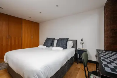 a bedroom with a large white bed in a room at Liverpool Warehouse Flat - Sleeps 5, WiFi, Free On-Site Parking in Liverpool