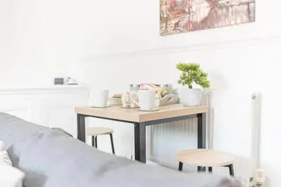 a small table with two stools in a bedroom at Cozy & Modern Accommodation in Barrow-in-Furness in Barrow in Furness