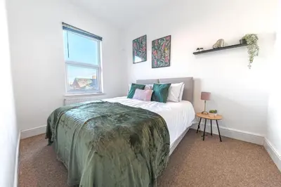a white bedroom with a bed and a window at Cozy & Modern Accommodation in Barrow-in-Furness in Barrow in Furness