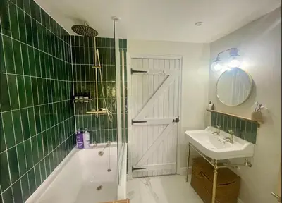 a bathroom with a tub and a sink and a shower at Squirrel Cottage in Ribchester